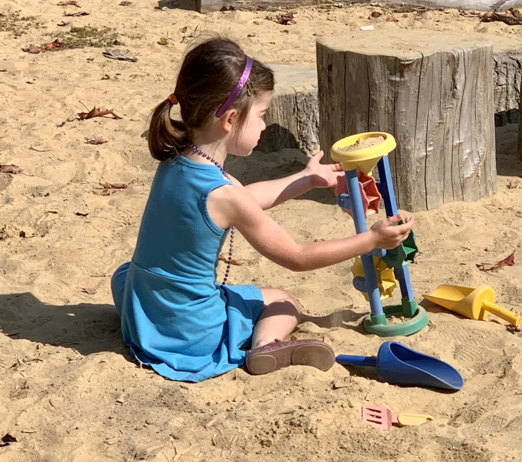 girl playing in the sand